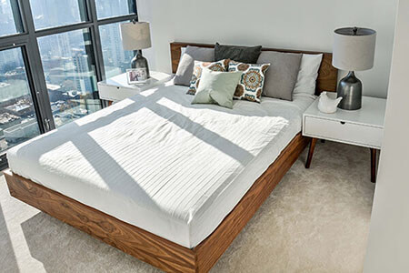 Bedroom with walnut bed and white nightstands