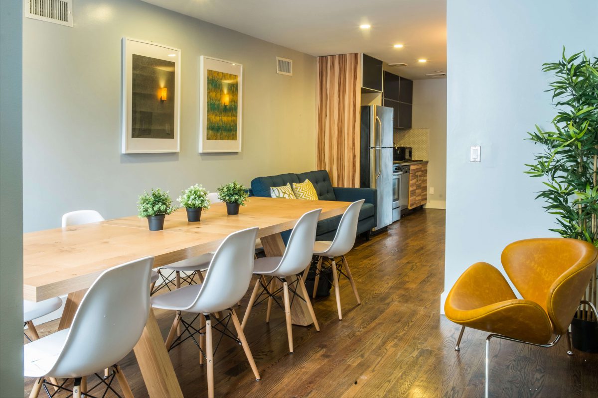 Natural wood dining table and classic white Eames dining chairs