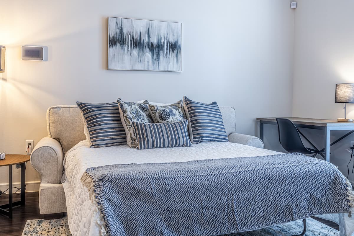 bedroom with throw pillows, mattress