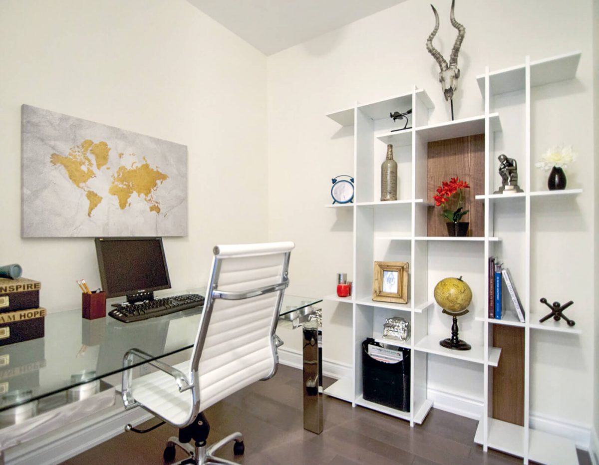 Glass desk with white office chair and white bookshelf