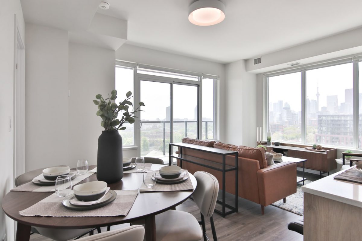 dining table with 4 dining chairs behind a sofa