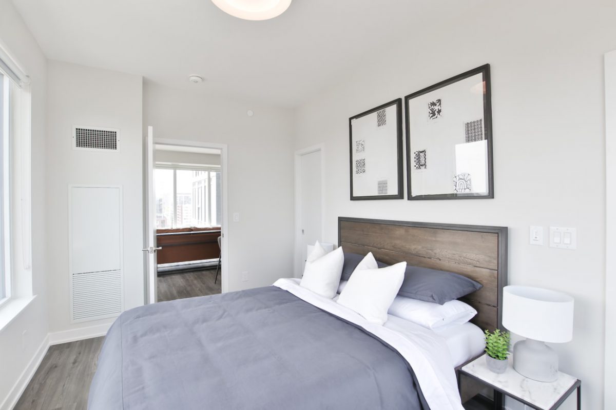 bedroom with wall art, side table and pillows