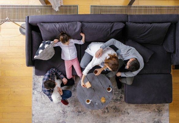 a family enjoying their time on the sofa with the coffee table in front