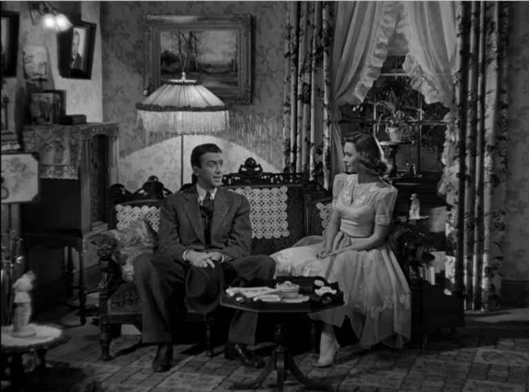 George and Mary sit together on a low settee, in Mary's childhood home.