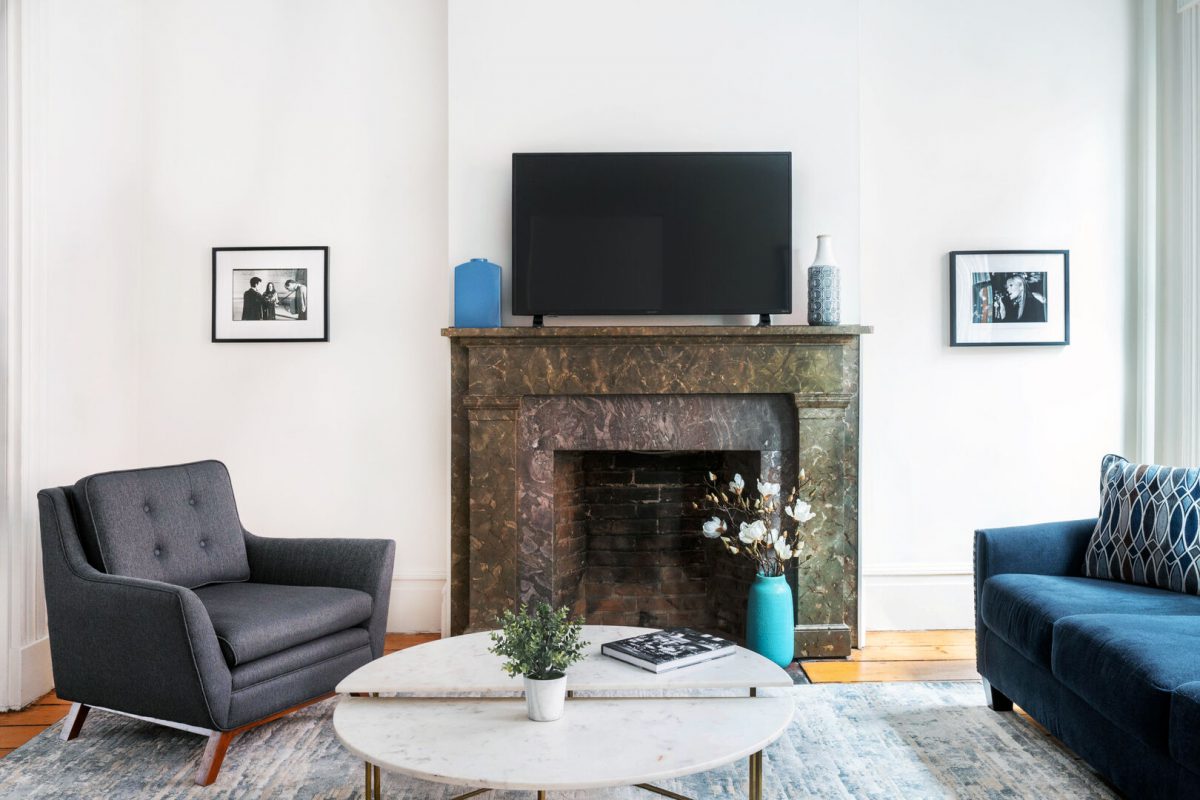 Jason's west village airbnb living room with a fireplace, coffee table, a chair and a couch