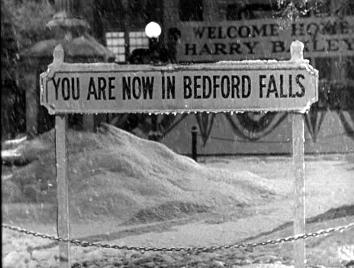 A sign with drifts of snow announces "You are now in Bedford Falls"